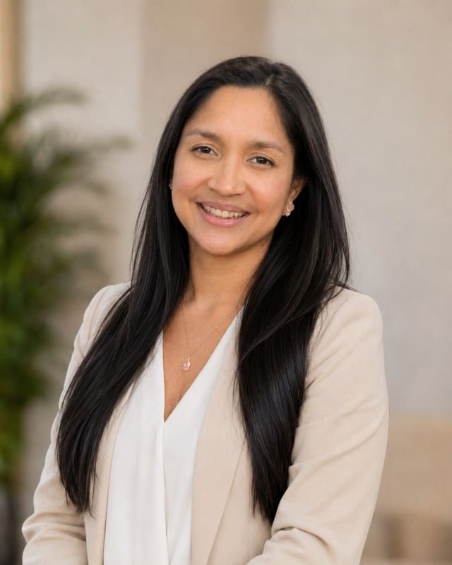 Emely Toledo, UGC creator, smiling in a beige blazer